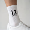 Calcetines Ayrton Senna 12, temporada 1988 blanco, primer plano del motivo tejido