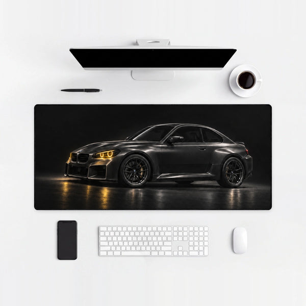 Alfombrilla de ratón BMW M2 negro faros amarillos, sobre un escritorio claro con ordenador, teclado y ratón